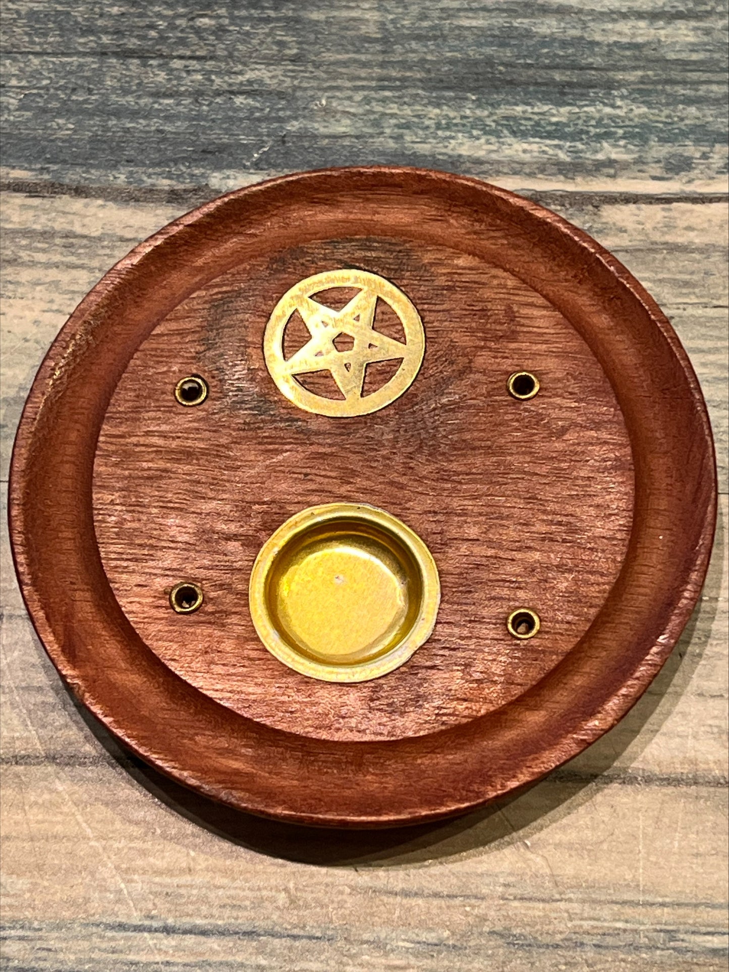 Circular wooden pentagram incense catcher.